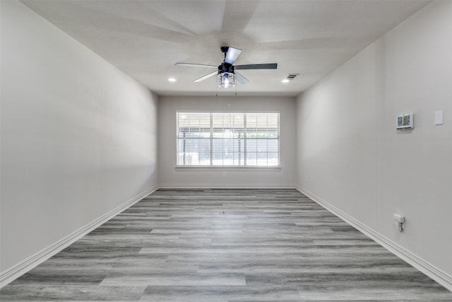 unfurnished room with ceiling fan and light hardwood / wood-style flooring