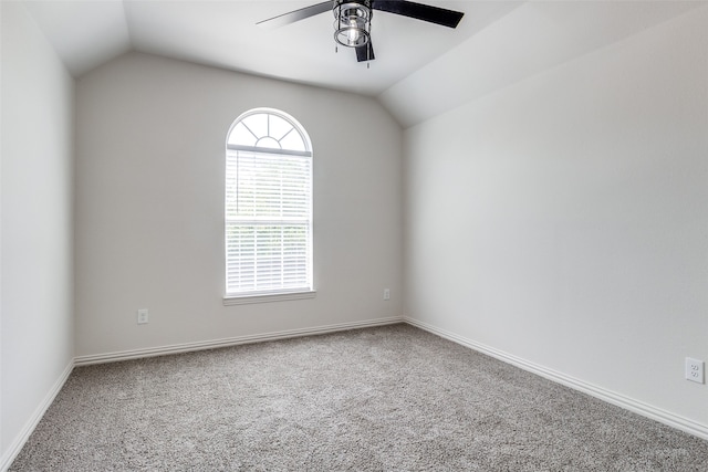 carpeted empty room featuring vaulted ceiling and ceiling fan