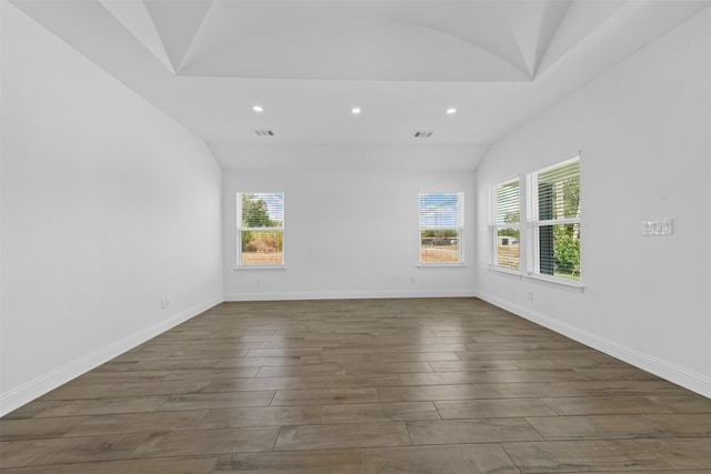 unfurnished room with wood-type flooring and vaulted ceiling