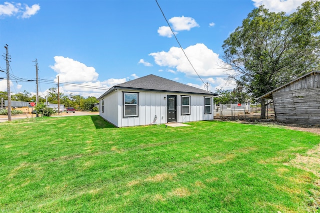 rear view of property featuring a lawn and a patio