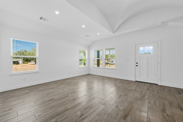 interior space with lofted ceiling and light hardwood / wood-style floors