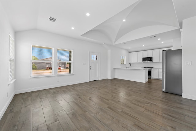 unfurnished living room with lofted ceiling and hardwood / wood-style flooring