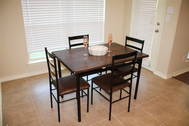 dining space featuring light tile patterned floors