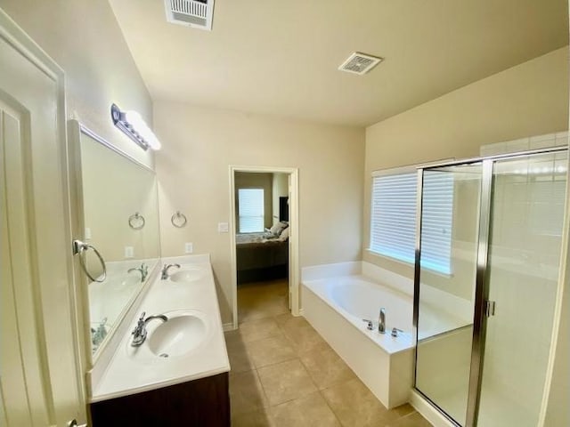 bathroom featuring vanity, independent shower and bath, and tile patterned floors