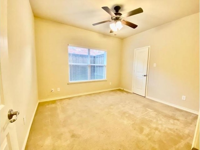 spare room featuring ceiling fan and carpet floors