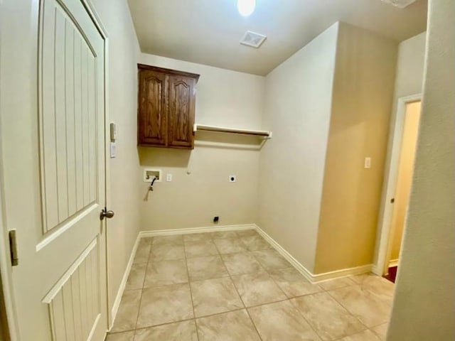 laundry area featuring light tile patterned floors, washer hookup, hookup for an electric dryer, and cabinets