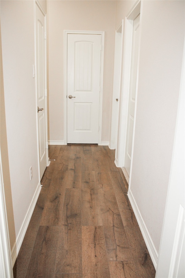 corridor featuring dark hardwood / wood-style flooring