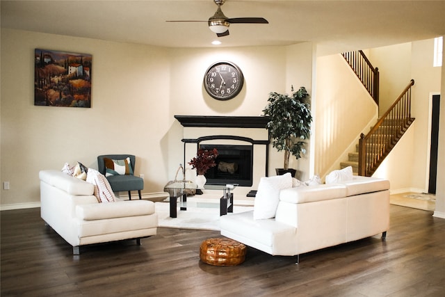 living room with dark hardwood / wood-style floors and ceiling fan