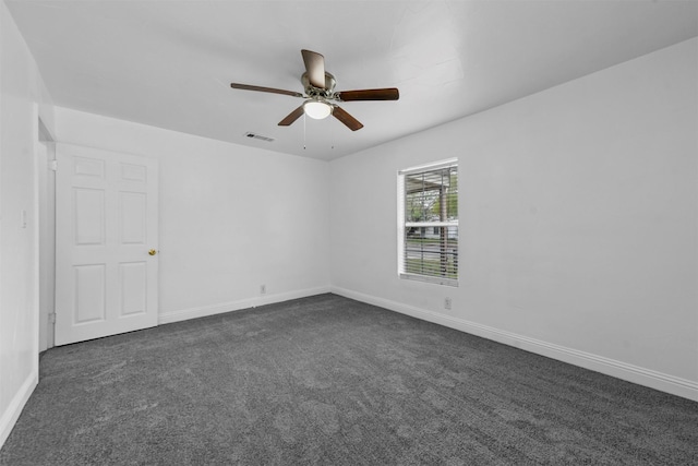 carpeted spare room featuring ceiling fan