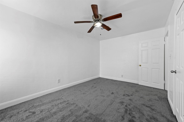 carpeted spare room featuring ceiling fan