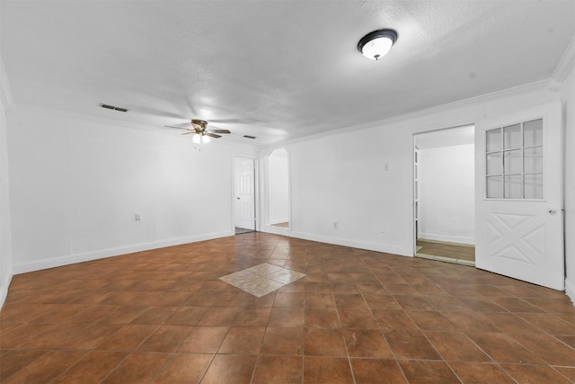 spare room featuring crown molding, a textured ceiling, dark tile patterned flooring, built in features, and ceiling fan