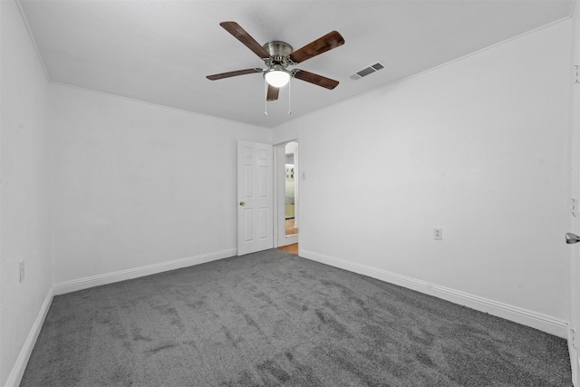 carpeted spare room featuring ceiling fan and ornamental molding