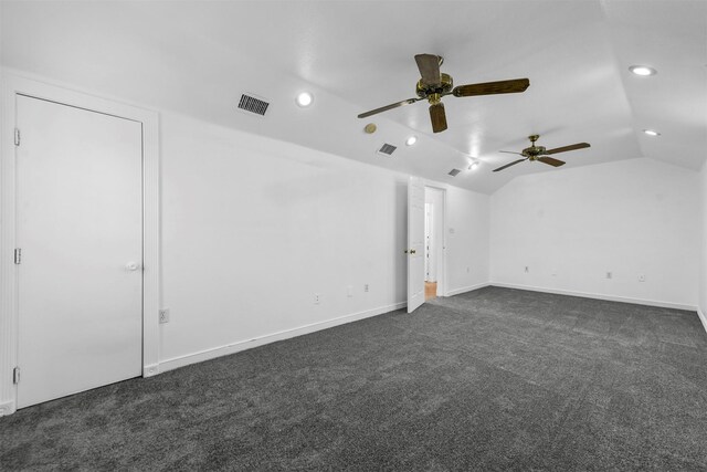 carpeted empty room featuring ceiling fan and vaulted ceiling