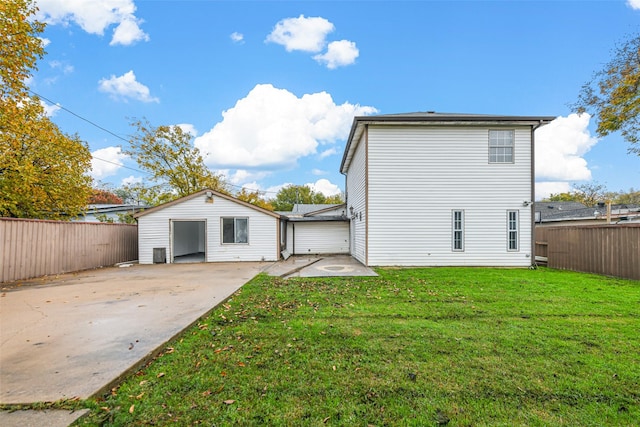 rear view of house featuring a yard and a patio