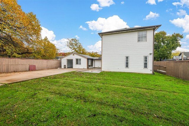 back of house with a patio area and a lawn