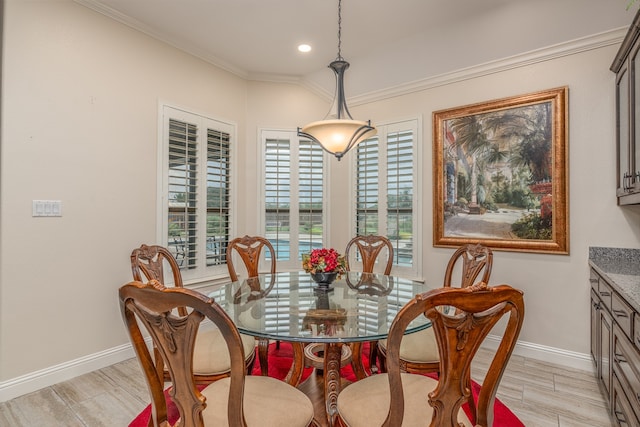 dining space with crown molding and light wood-type flooring