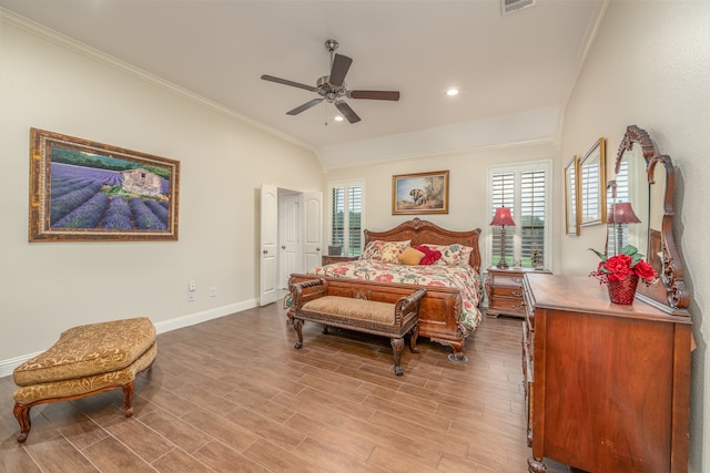 bedroom featuring hardwood / wood-style floors, ceiling fan, and crown molding