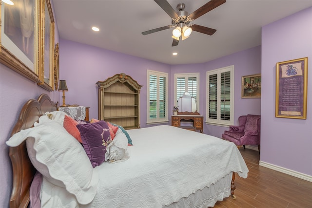 bedroom with ceiling fan and dark hardwood / wood-style flooring