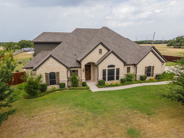 french country style house featuring a front lawn