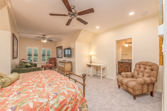 carpeted bedroom with ensuite bath, ornamental molding, and ceiling fan