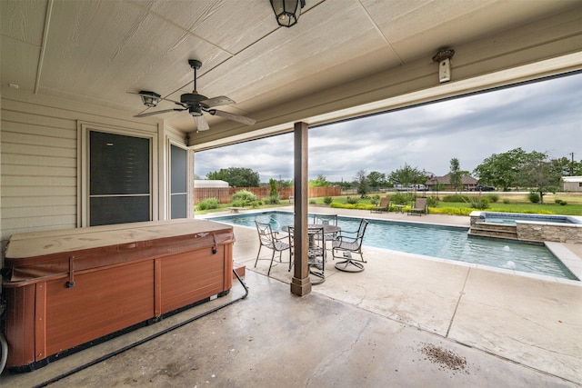 view of swimming pool featuring ceiling fan, a patio, and a hot tub