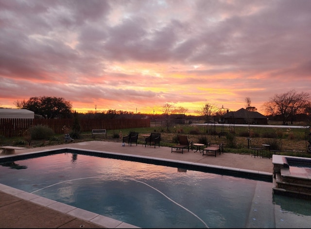 view of pool at dusk