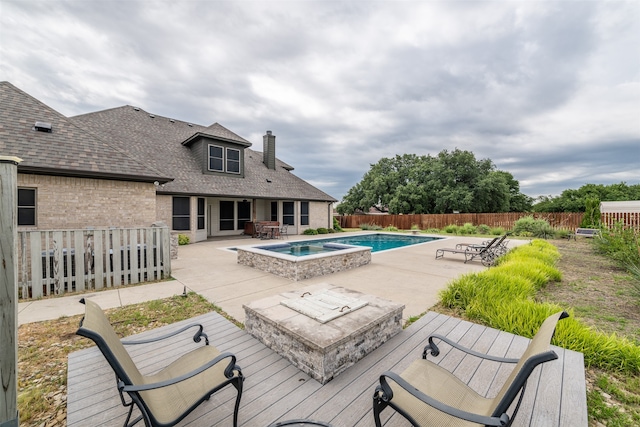 view of swimming pool featuring a patio and an in ground hot tub