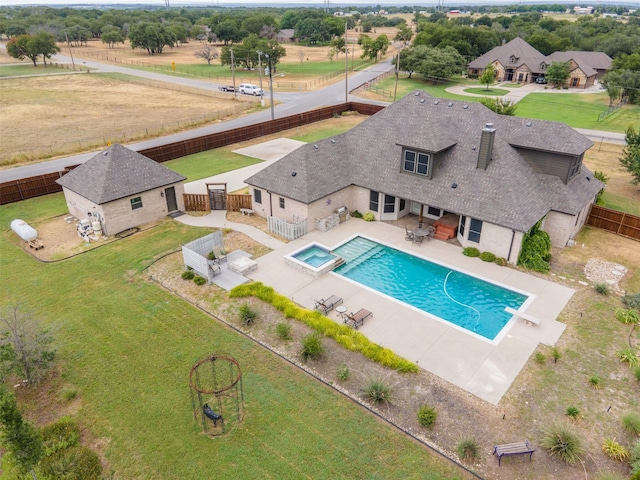 view of pool with a diving board, a lawn, and a patio