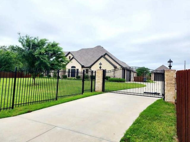 view of gate featuring a lawn