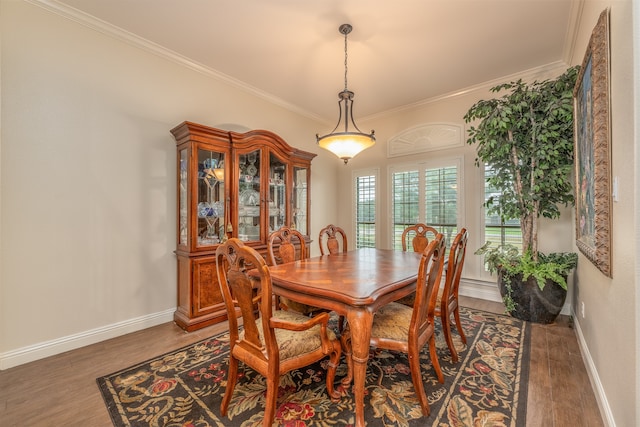 dining room featuring dark wood-type flooring and crown molding