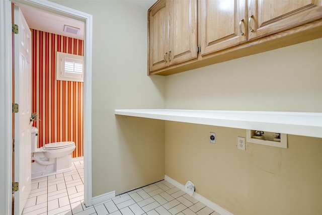 clothes washing area featuring hookup for a washing machine, cabinets, and electric dryer hookup