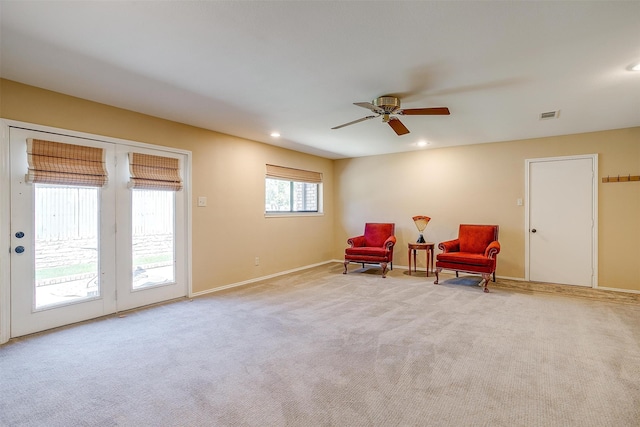 sitting room with light colored carpet and ceiling fan