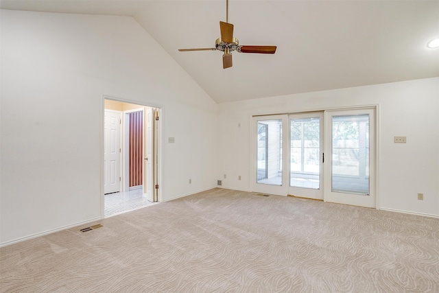 empty room with light colored carpet, high vaulted ceiling, and ceiling fan