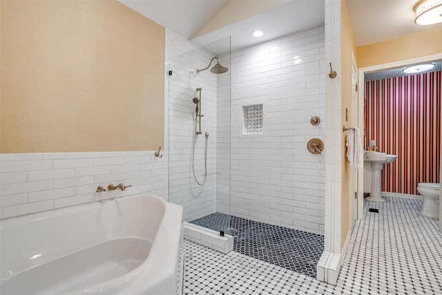 bathroom with tile patterned flooring, toilet, plus walk in shower, and lofted ceiling