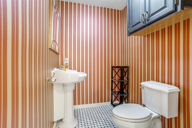 bathroom featuring toilet and tile patterned floors