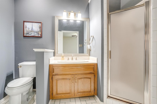 bathroom featuring tile patterned flooring, toilet, a shower with door, and vanity