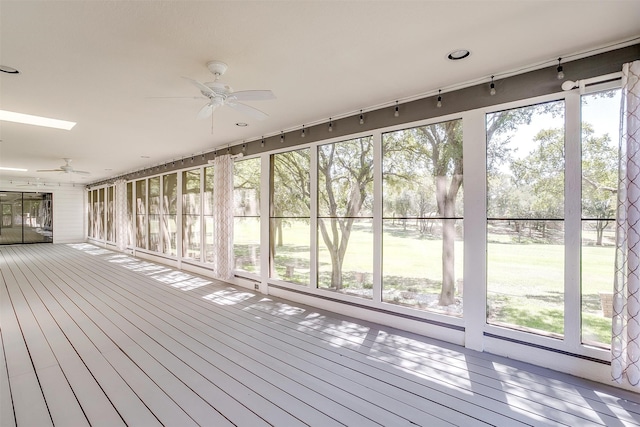 interior space with a healthy amount of sunlight, a skylight, and ceiling fan