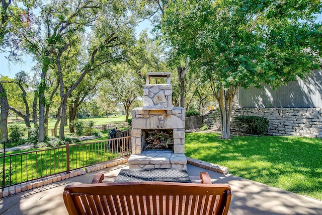 view of patio featuring an outdoor stone fireplace