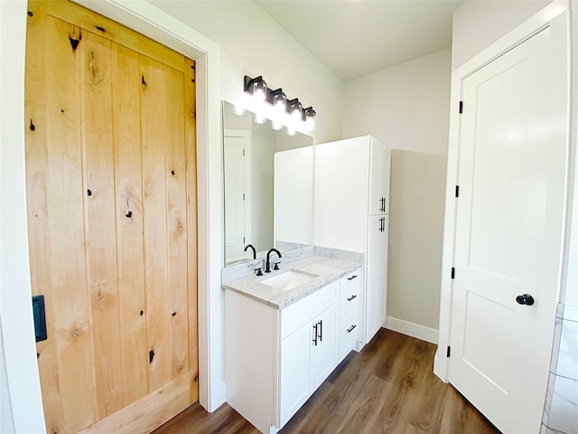 bathroom featuring vanity and wood-type flooring