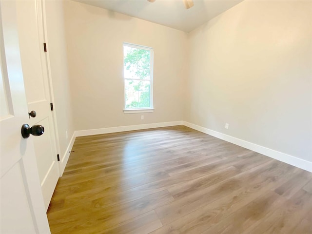 spare room featuring light hardwood / wood-style flooring and ceiling fan