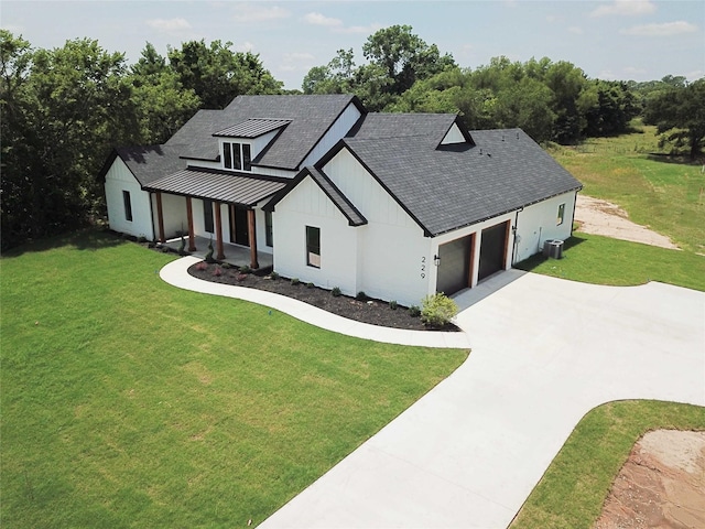 modern inspired farmhouse with a front lawn and cooling unit