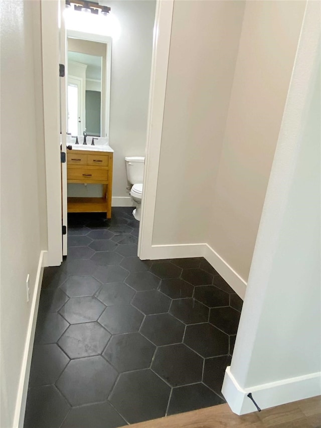 bathroom featuring vanity, toilet, and tile patterned floors