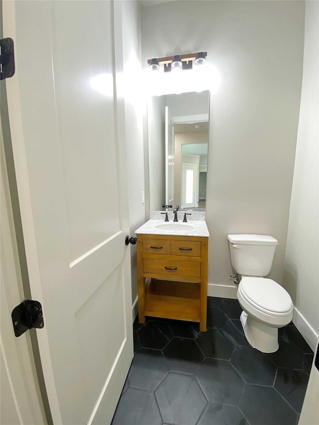 bathroom with tile patterned flooring, toilet, and vanity