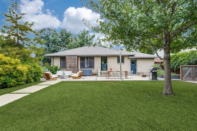 back of property featuring an outdoor living space, a patio area, and a lawn