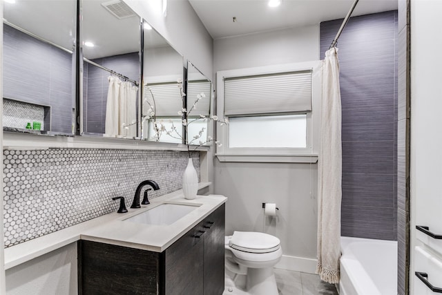 full bathroom featuring decorative backsplash, toilet, vanity, and shower / tub combo