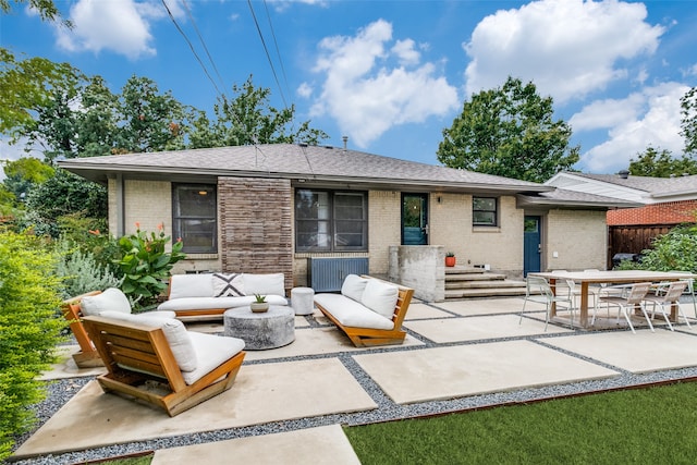 back of property featuring outdoor lounge area and a patio area