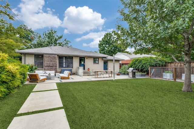 back of property with outdoor lounge area, a yard, and a patio