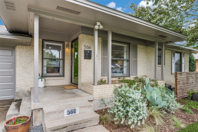 view of exterior entry featuring a porch