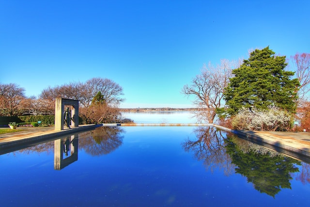 view of swimming pool featuring a water view