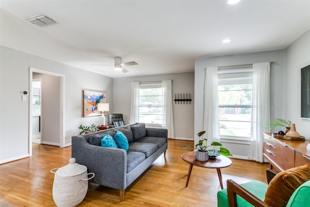 living room featuring light wood-type flooring and ceiling fan